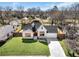 Aerial view of a lovely white brick home with a manicured lawn and mature trees at 1774 Vesta Ave, Atlanta, GA 30337