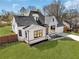 Aerial view of a lovely white brick home with a manicured lawn and mature trees at 1774 Vesta Ave, Atlanta, GA 30337