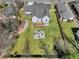 Aerial view of a private backyard oasis with a stone fire pit and mature trees at 1774 Vesta Ave, Atlanta, GA 30337