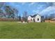 Spacious backyard features a large grassy area, fire pit, and wooden fence perfect for outdoor living at 1774 Vesta Ave, Atlanta, GA 30337