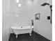 Stylish bathroom features a clawfoot tub, black fixtures, and modern tile work at 1774 Vesta Ave, Atlanta, GA 30337