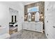 Modern bathroom with double vanity, decorative mirrors, tiled floors and view to main bedroom at 1774 Vesta Ave, Atlanta, GA 30337