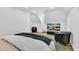 This modern bedroom includes a large TV, black leather chairs, and sleek furnishings at 1774 Vesta Ave, Atlanta, GA 30337