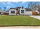 Charming white brick home features a well-manicured lawn and a two-car garage at 1774 Vesta Ave, Atlanta, GA 30337