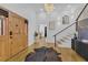 Bright foyer with wood floors, stairs with rod iron railing and chandelier lighting at 1774 Vesta Ave, Atlanta, GA 30337