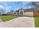 A charming brick home featuring a modern design, a spacious driveway and an attached garage at 1774 Vesta Ave, Atlanta, GA 30337