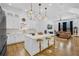 Open concept kitchen with pendant lights over island, bar stools, and view to the living room at 1774 Vesta Ave, Atlanta, GA 30337