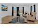Open living room with hardwood floors, large windows, and comfortable seating area at 1774 Vesta Ave, Atlanta, GA 30337