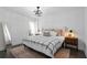 Bright bedroom showcasing a ceiling fan, a rug, a bed, and a nightstand at 2614 Talley St, Decatur, GA 30030