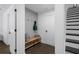 Hallway featuring wood floors, shiplap accent wall, coat hooks, and a staircase at 2614 Talley St, Decatur, GA 30030