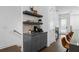 Cozy kitchenette features gray cabinets, floating shelves and hardwood floors at 2614 Talley St, Decatur, GA 30030