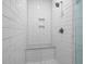 Modern shower featuring white subway tile, a built-in bench, and convenient shower niche at 2614 Talley St, Decatur, GA 30030