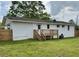 The backyard features a wooden deck, green grass, and white exterior walls, perfect for outdoor living at 262 E Main St, Rutledge, GA 30663