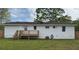 The backyard features a wooden deck, green grass, and white exterior walls, perfect for outdoor living at 262 E Main St, Rutledge, GA 30663