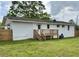 The backyard features a wooden deck, green grass, and white exterior walls, perfect for outdoor living at 262 E Main St, Rutledge, GA 30663