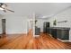 Hardwood floors connect open floor plan from living room to the kitchen with stainless appliances at 262 E Main St, Rutledge, GA 30663