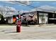 Patriotic mural adorns a building on a street corner, featuring American flags and military figures at 262 E Main St, Rutledge, GA 30663