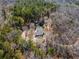Aerial view of home nestled in wooded lot with mature trees and private setting at 4941 N Helton Rd, Winston, GA 30187