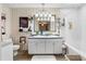 Bathroom featuring double sinks, an elegant light fixture, and a shower-tub combination at 4941 N Helton Rd, Winston, GA 30187