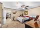 Bedroom showcasing a patterned bedspread, ceiling fan, and a view into the living area at 4941 N Helton Rd, Winston, GA 30187