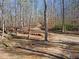 A long private driveway leads to a secluded homesite amongst the trees at 4941 N Helton Rd, Winston, GA 30187