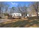 Exterior view of a single-story home with a driveway and multiple decks at 4941 N Helton Rd, Winston, GA 30187