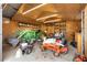 Well-equipped garage filled with tractors and lawn care equipment, offering storage and workspace at 4941 N Helton Rd, Winston, GA 30187