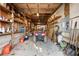 Spacious garage with wooden shelves, storage, and an ATV, providing ample space for equipment and hobbies at 4941 N Helton Rd, Winston, GA 30187