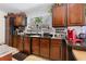Bright kitchen featuring dark wood cabinets and granite countertops at 4941 N Helton Rd, Winston, GA 30187
