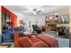 Cozy living room with a stone fireplace, plush seating, and a ceiling fan at 4941 N Helton Rd, Winston, GA 30187