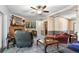 Living room featuring a ceiling fan, stone fireplace, and comfortable furniture at 4941 N Helton Rd, Winston, GA 30187