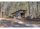 An outbuilding with a woodpile sits within a beautiful wooded property at 4941 N Helton Rd, Winston, GA 30187