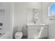 Cozy bathroom features a white vanity and a toilet next to a tiled shower and bathtub at 779 Keystone Dr, Woodstock, GA 30188