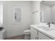 Contemporary bathroom with a sleek vanity, white toilet, and natural light from the window at 779 Keystone Dr, Woodstock, GA 30188