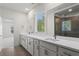 Bright bathroom featuring double sinks with white countertops and a glass-enclosed shower at 779 Keystone Dr, Woodstock, GA 30188