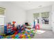 bedroom featuring neutral paint, a play area and an abundance of natural light at 779 Keystone Dr, Woodstock, GA 30188