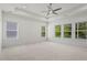 Spacious bedroom with large windows providing backyard views and plush carpeting at 779 Keystone Dr, Woodstock, GA 30188