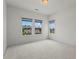 Carpeted bedroom filled with natural light from large windows overlooking the landscape at 779 Keystone Dr, Woodstock, GA 30188