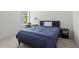 A well lit, carpeted bedroom with one window and a desk at 779 Keystone Dr, Woodstock, GA 30188