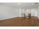 Bonus room with hardwood flooring features a stairway and white painted walls with a view of the landing at 779 Keystone Dr, Woodstock, GA 30188