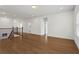 Large bonus room with hardwood floors, staircase with dark iron spindles, and plenty of natural light at 779 Keystone Dr, Woodstock, GA 30188