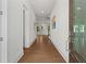 Bright hallway featuring hardwood floors and white walls leads to open, sunlit rooms at 779 Keystone Dr, Woodstock, GA 30188