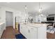 An eat-in kitchen features an island with a sink, bar seating, stainless appliances, and wood flooring at 779 Keystone Dr, Woodstock, GA 30188