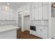 Spacious kitchen featuring white cabinets, stainless appliances, hardwood floors, and ample storage at 779 Keystone Dr, Woodstock, GA 30188