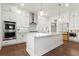 A modern, eat-in kitchen featuring an island and stainless steel appliances and stylish pendant lighting at 779 Keystone Dr, Woodstock, GA 30188