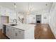 Open kitchen features a large island with modern appliances and connects to a spacious living area at 779 Keystone Dr, Woodstock, GA 30188