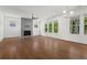 Spacious living room with fireplace, ceiling fan, and bright, natural light at 779 Keystone Dr, Woodstock, GA 30188