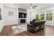 Cozy living room features a modern fireplace and a large, comfortable seating area at 779 Keystone Dr, Woodstock, GA 30188