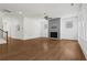 Open-concept living room with fireplace, ceiling fan, hardwood floors, and lots of light at 779 Keystone Dr, Woodstock, GA 30188