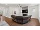 Spacious living room with hardwood floors, fireplace and comfortable wrap-around seating at 779 Keystone Dr, Woodstock, GA 30188